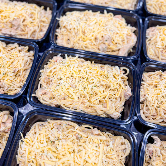 AVAILABLE NOW, FROZEN- Chicken cubes in a honey mustard sauce, spaghetti, and fresh gouda cheese on top.