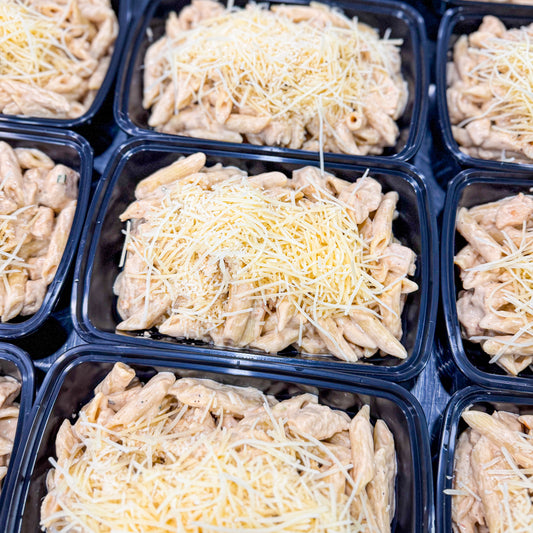 AVAILABLE NOW, FROZEN- Alfredo penne with chicken cubes, crispy bacon, and fresh Parmesan cheese on top.